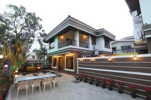 a house with tables and chairs in front of it at Aashiyaanaa villa "IMPERIAL" in Lonavala