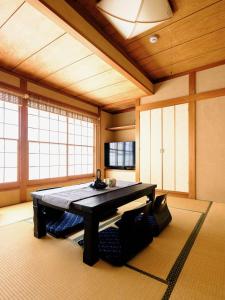 a room with a table in the middle of a room at Home n Lounge in Tokyo