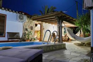 un patio avec un hamac et une piscine dans l'établissement Tinyhouse im Patio einer romantischen Finca, à Grima