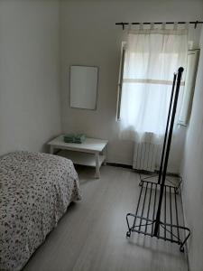 a bedroom with a bed and a chair next to a window at Il Borgo in Corbara