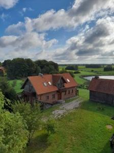 a large house in the middle of a field at Kumaczówka Mazury in Ruciane-Nida