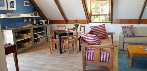 a living room with a table and chairs at Hemel en Aarde Village Accommodation in Hermanus