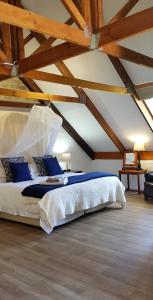 a bedroom with a large bed with wooden ceilings at Hemel en Aarde Village Accommodation in Hermanus