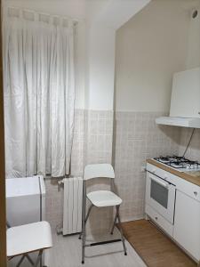 a kitchen with a stove and a chair in it at Il Borgo in Corbara