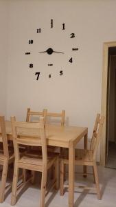 a table and chairs with a clock on the wall at Il Borgo in Corbara