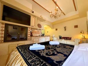 a bedroom with a bed and a tv on the wall at Palazzo Barbini Dimora Storica in Castiglione del Lago