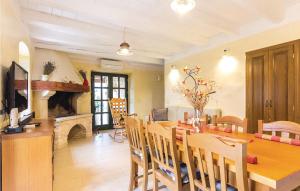 a dining room with a table and a fireplace at 2 Bedroom Lovely Home In Sisan in Šišan