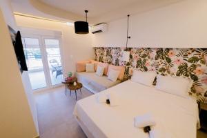 a living room with two beds and a couch at Loutraki Pinky Pearl in Loutraki