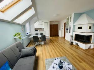 a living room with a couch and a fireplace at Apartament Bystrzycka in Gdańsk