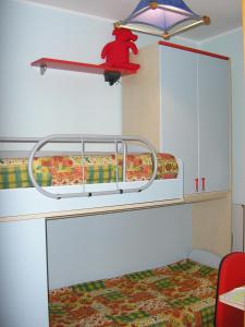a bunk bed with a red bear on a shelf at Baglio Makari in San Vito lo Capo