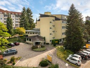 an apartment building with cars parked in a parking lot at Hotel Häfner in Bad Schonborn