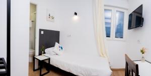 A bed or beds in a room at GOLDEN TORREJON