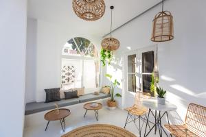 a living room with a couch and chairs and a window at Eleana Hotel in Tinos