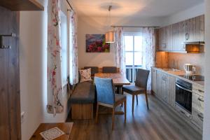 a kitchen with a table and chairs in a room at Weitgasserhof in Schladming +41 photos