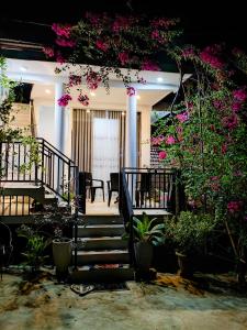 a stairway with pink flowers on a building at Flower Shade Villa in Weligama