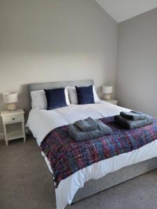 a bedroom with a large bed with towels on it at Loughinvar, Newtownards in Newtownards