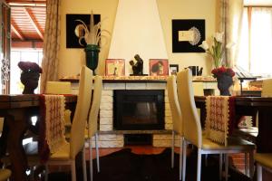 a dining room with a fireplace and a table and chairs at Villa Marisa in Pavia