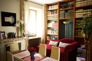 sala de estar con sofá rojo y chimenea en Villa Marisa, en Pavia