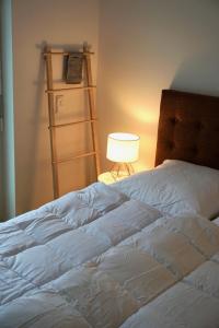 - une chambre avec un lit blanc et une lampe dans l'établissement Strandglück, à Scharbeutz