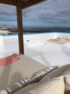 A balcony or terrace at COZY, Beach House , by MAHBOVILLAS