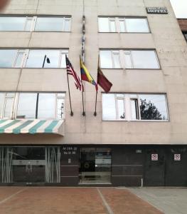 two flags on the front of a building at Hotel Arena Plaza Inn in Bogotá
