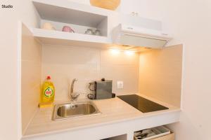 a kitchen with a sink and a counter top at Aria Apartments in Spetses
