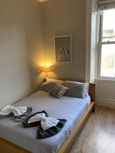 a bedroom with a bed with two towels on it at 'Bloomfield' at stayBOOM in Lancaster