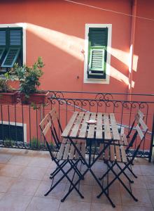 a wooden table and chairs sitting next to a building at Casa Duke in Corniglia