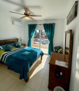 a bedroom with a bed and a window at 109 Queens Gardens, Paphos in Paphos