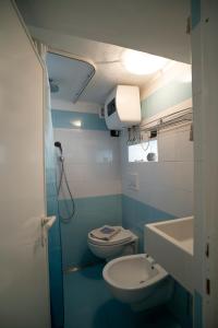 a blue bathroom with a toilet and a sink at Borgo Antico - Il nido di briciola in Lerici