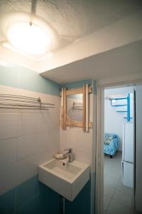 a bathroom with a sink and a mirror at Borgo Antico - Il nido di briciola in Lerici