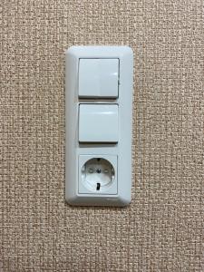 a white electrical outlet sitting on the floor at Apartment on Turku in Saint Petersburg