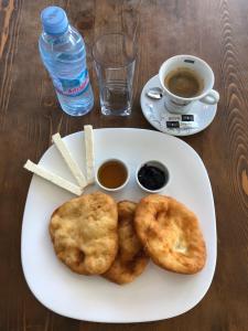 a plate of food with biscuits and a cup of coffee at MOBI DICK Family Hotel in Glavatartsi