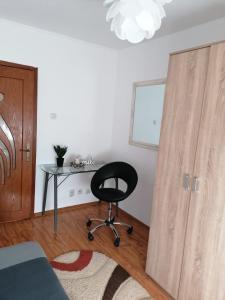 a room with a desk and a chair next to a door at Masaryss apartament Tulcea in Tulcea