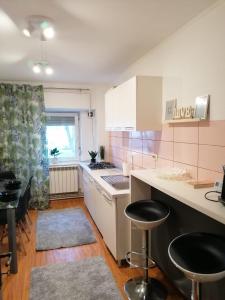 a kitchen with white cabinets and a counter top at Masaryss apartament Tulcea in Tulcea