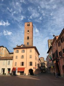 a building with a tall tower on top of it at La Corte in Alba