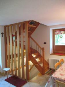 a wooden staircase in a room with a window at Chalet Borney in Fontainamore