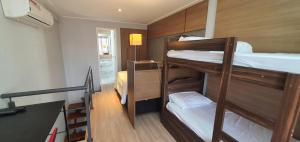 two bunk beds in a small room with a ladder at Duplex NYC Berrini - 1305 in Sao Paulo