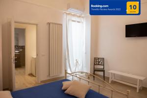 a bedroom with a bed and a tv on a wall at CASA ELISA in Monopoli