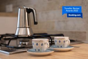 two cups on a counter with a tea kettle at CASA ELISA in Monopoli +13 photos