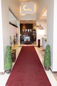 a red carpet leading to a living room with a red carpet at الليل لك للشقق الفندقيه in Hail