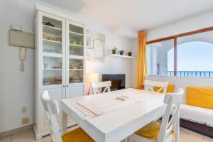 a kitchen and dining room with a white table and chairs at Altea Top Quality Duplex-home in Altea