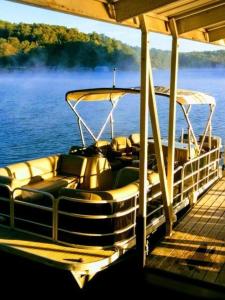 a boat sitting on a dock on the water at Lake views galore from balconies right on the lake and drought-proof deep water in Murrayville