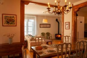 a dining room and living room with a table and chairs at CASA TEO in Chañe