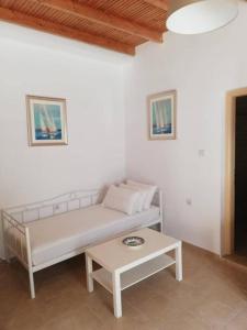 a white couch in a room with a table at Maistrali in Loutro