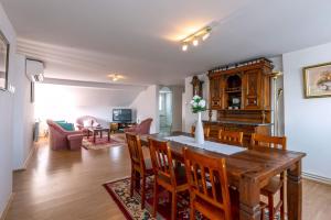 a kitchen and living room with a table and chairs at Mott Residence in Tuzla