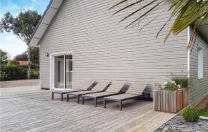 a group of chairs sitting on a wooden deck at Stunning Home In Herly in Herly +35 photos