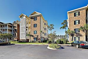 a parking lot in front of a large building at Magnolia Point Apt 204 in Myrtle Beach