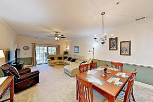 a living room with a table and a couch at Magnolia Point Apt 204 in Myrtle Beach
