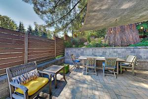 a patio with chairs and tables and a fence at Big Dream in Seattle